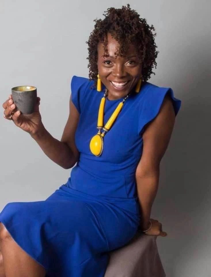Dr. Danielle Nicole Johnson wearing blue with yellow jewelry.